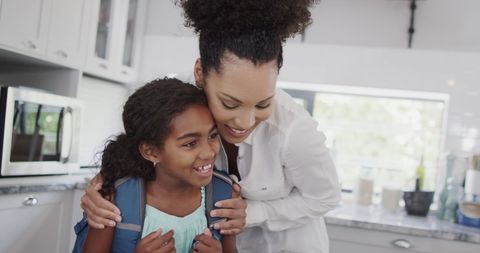 Happy Biracial Mother Hugging Daughter in Bright Kitchen - Download Free Stock Images Pikwizard.com