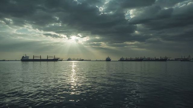 Cargo Ships in Serene Harbor Waters at Dawn