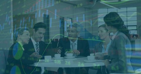 Colleagues analyzing market trends in corporate lounge over coffee