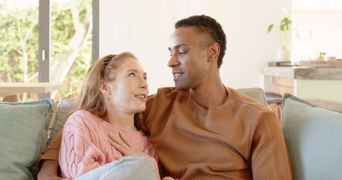 Romantic Couple Talking on Cozy Sofa at Home
