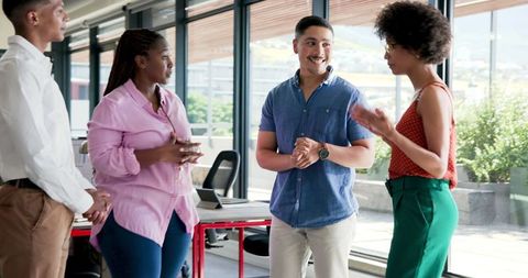 Diverse Colleagues Engaging in Teamwork in Modern Office
