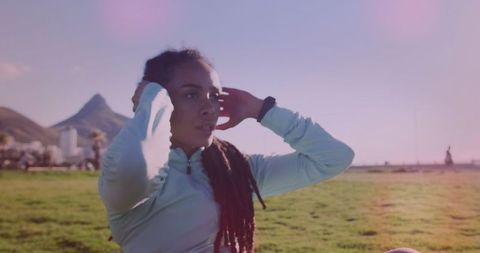 Biracial Woman Exercising Outdoors in Park with Mountain View