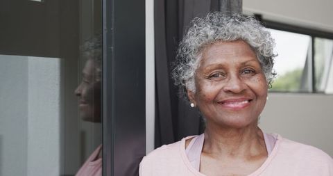 Happy Senior African American Woman Smiling by Window