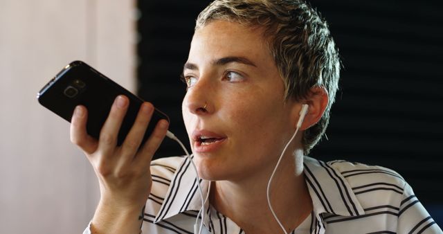 Woman Using Voice Command on Smartphone with Earbuds - Download Free Stock Images Pikwizard.com