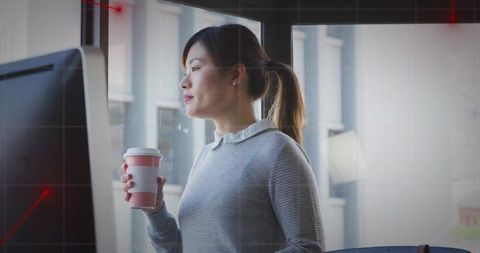 Professional Woman Holding Coffee in Modern Office with City View