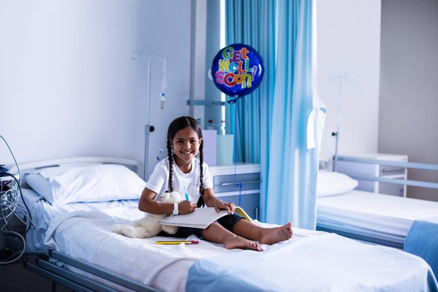 Smiling Girl Drawing on Hospital Bed with Get Well Soon Balloon - Download Free Stock Photos Pikwizard.com