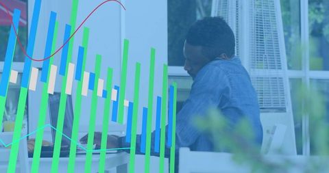 Data analyst working on laptop with colorful analytics overlay and coworking workspace