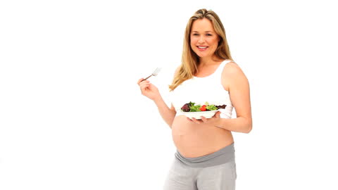 Smiling Pregnant Woman Enjoying Fresh Salad