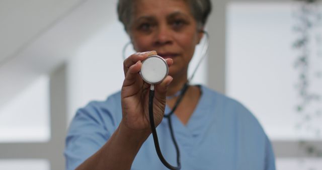 Experienced Doctor Holding Stethoscope and Looking at Camera - Download Free Stock Images Pikwizard.com