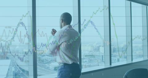 Businessman Analyzing Financial Data with City View