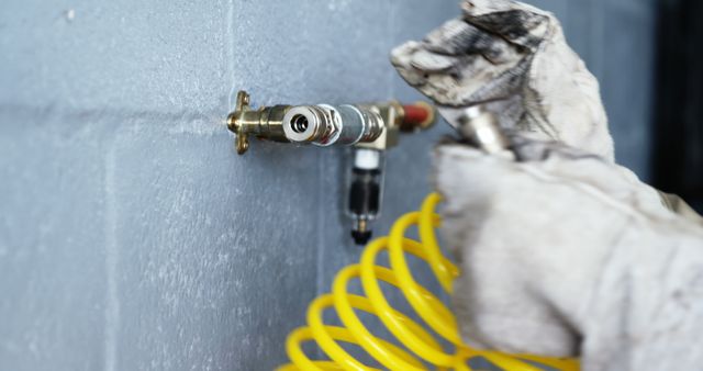 Close-up of Mechanic Hands with Gloves Using Air Pump Hose Connection - Download Free Stock Images Pikwizard.com