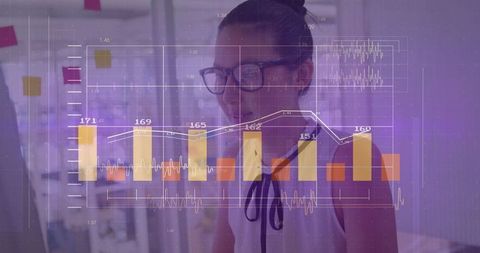 Businesswoman analyzing data with digital charts in modern office