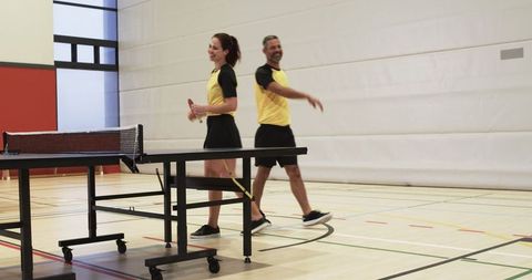 Athletes Walking Off Table Tennis Court After Match