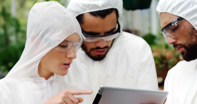 Scientists in Protective Suits Monitoring Data on Tablet - Download Free Stock Images Pikwizard.com