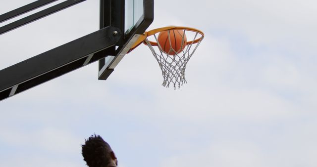 Basketball going into hoop during outdoor game - Download Free Stock Images Pikwizard.com