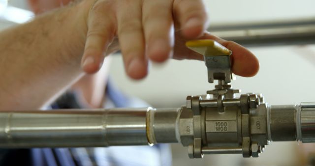 Technician Adjusting Industrial Valve on Metal Pipe - Download Free Stock Images Pikwizard.com