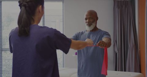 Senior Man Engaging in Rehabilitation with Physical Therapist