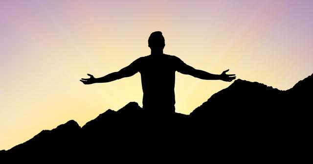 Digital composite of Silhouette man with arms outstretched standing on mountain during sunset