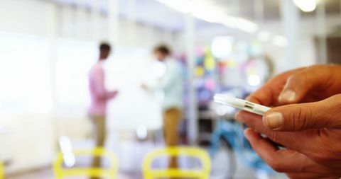 Businessman texting in modern office workspace