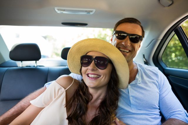 Cheerful couple wearing sunglasses in car - Download Free Stock Photos Pikwizard.com