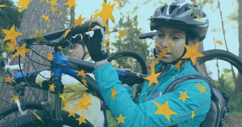 Cycling Partners Carrying Bikes Through Scenic Forest
