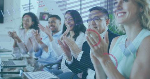 Team applauding innovative business solutions with statistical projections