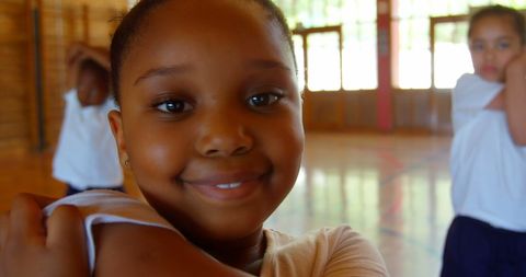 Smiling School Child Doing Yoga in Gym Class