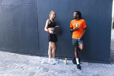 Friends Enjoying Padel Together on Urban Sports Court