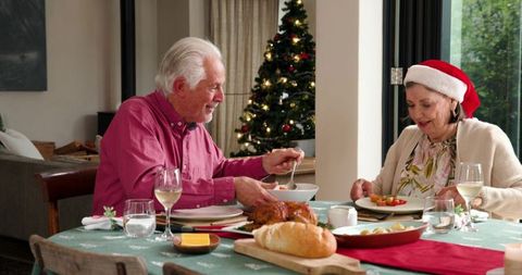 Senior Couple Celebrating Christmas Together at Table