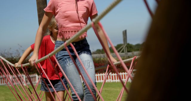 Children Enjoying Outdoor Rope Bridge Adventure at Kid's Playground - Download Free Stock Images Pikwizard.com