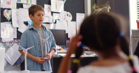 Elementary Student Presenting Windmill Model in Classroom - Download Free Stock Images Pikwizard.com