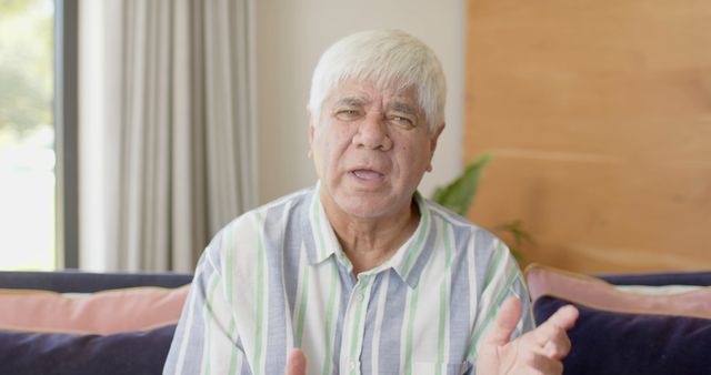 Elderly Man Speaking and Gesturing in Living Room - Download Free Stock Images Pikwizard.com