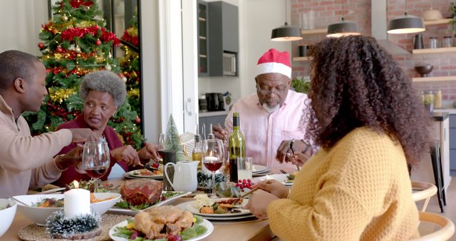 Family Enjoying Christmas Feast Around Dining Table with Decorations - Download Free Stock Images Pikwizard.com