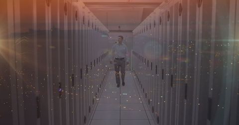Male Engineer Walking in Modern Server Room With City Overlay - Download Free Stock Images Pikwizard.com