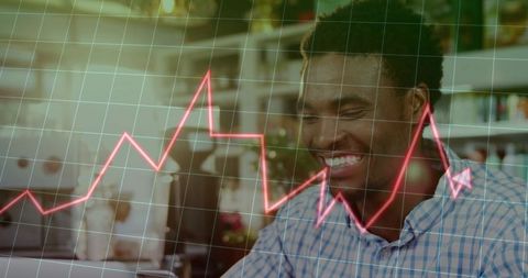 Smiling man working on laptop with rising red analytics chart overlay showing growth boost