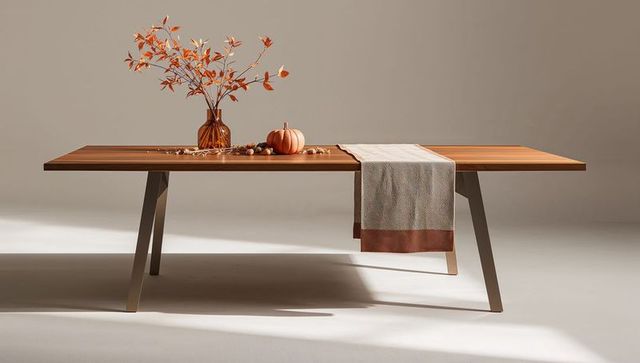 Minimalist Wooden Dining Table with Angled Legs, Amber Vase, Pumpkin and Autumn Runner