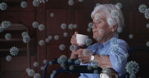 Elderly Woman in Wheelchair Sipping Coffee Amidst Virus Illustrations