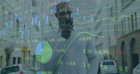 Businessman speaking into smartphone with stock market data overlay on urban street