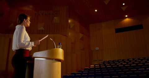 Confident Businesswoman Rehearsing Speech in Auditorium - Download Free Stock Images Pikwizard.com