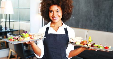 Cheerful Waitress Holding Sandwich Platters in Modern Restaurant - Download Free Stock Images Pikwizard.com