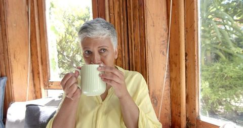 Senior Woman Enjoying Relaxing Tea Break at Home
