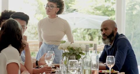 Diverse group enjoying drinks at outdoor wedding celebration