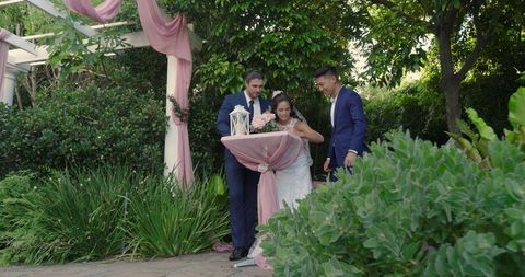 Bride and groom joyfully walking in beautiful garden during wedding celebration