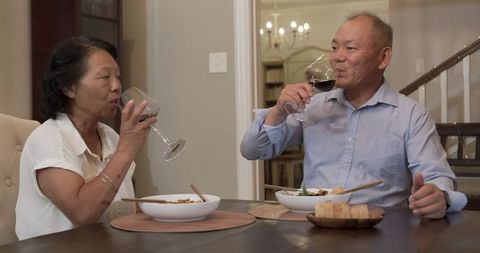 Senior Couple Enjoying Wine and Dinner at Home Together