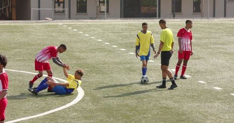 Teenage soccer players exhibiting sportsmanship and team camaraderie