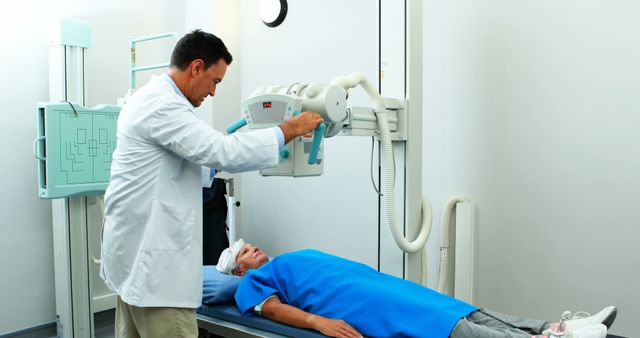 Doctor Operating X-ray Machine in Hospital with Hurt Patient on Bed - Download Free Stock Images Pikwizard.com