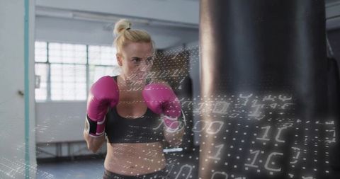 Determined Female Boxer Training with Binary Code Overlay