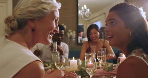 Family Celebrating at Candlelit Dinner with Joyful Conversations