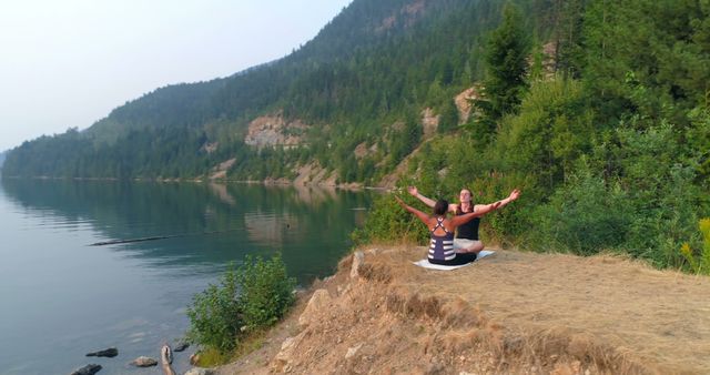 Women Practicing Yoga on Lake Shore with Pine Forest in Background - Download Free Stock Images Pikwizard.com