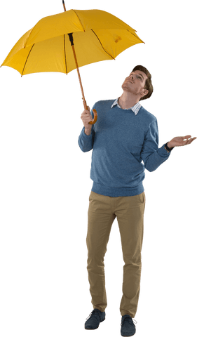 Young man holding yellow umbrella looking upwards transparent background